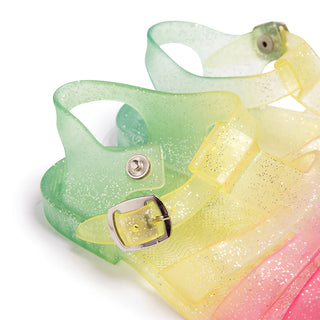 Shooshoos Jelly Sandal for girls, right foot, rainbow glitter design, with buckle closure, made of transparent jelly material.